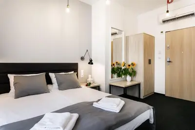 a bedroom with a large bed with towels on it at Happy Apartments in Kraków