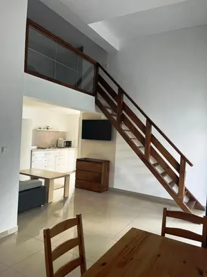 a bedroom with two beds and a dining room with a table at Domki Cztery Pory Roku in Czchów