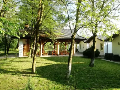 a patio with a row of black chairs at Domki Cztery Pory Roku in Czchów