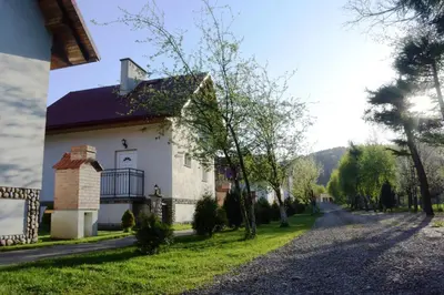 a house with a gazebo in a yard at Domki Cztery Pory Roku in Czchów