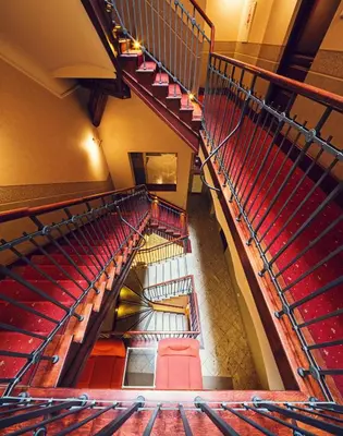 an overhead view of an auditorium with red seats at Calliope Apartments in Kraków