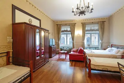 a bedroom with two beds and a chandelier at Calliope Apartments in Kraków