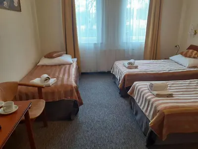 a hotel room with two beds and a table at Salis Resort in Wieliczka