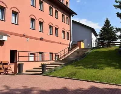 a large brick building with stairs next to a building at Salis Resort in Wieliczka