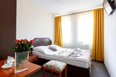 a hotel room with a bed and a table at Salis Resort in Wieliczka