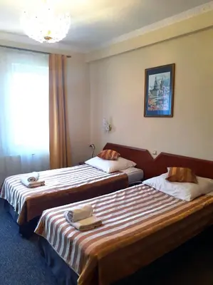 a hotel room with two beds with towels on them at Salis Resort in Wieliczka