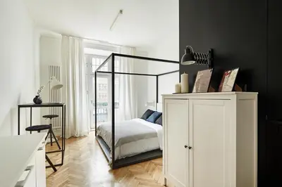 a bedroom with a canopy bed and a white cabinet at FOUR STORIES APARTMENTS - Krasinskiego in Kraków