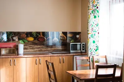 a kitchen with a table and a microwave at Apartamenty Gorczańskie in Rabka