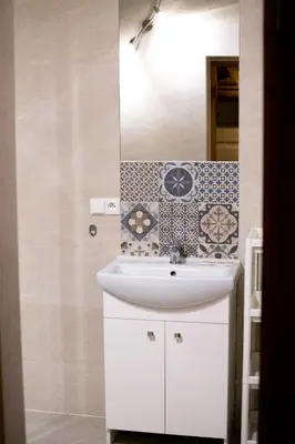 a bathroom with a white sink and a mirror at Apartamenty Gorczańskie in Rabka
