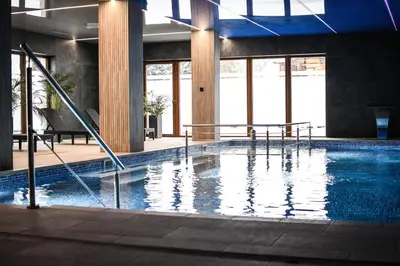 a large swimming pool in a building at Apartamenty Gorczańskie in Rabka