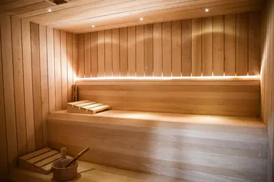 a sauna with a bench in a wooden room at Apartamenty Gorczańskie in Rabka