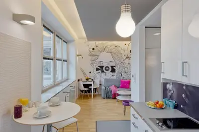 a kitchen and living room with a table and chairs at Centre Apartments-Old Town in Kraków