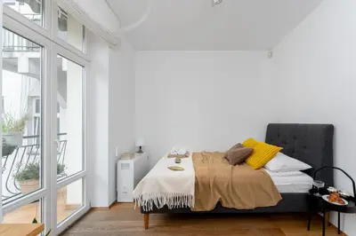 a white bedroom with a bed with a blanket at Centre Apartments-Old Town in Kraków