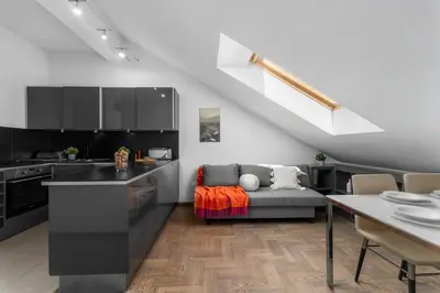 a kitchen and living room with a couch and a table at Centre Apartments-Old Town in Kraków
