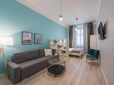 a living room with a couch and a table at Centre Apartments-Old Town in Kraków
