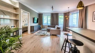 a living room with a couch and a table at A11 Apartments & SPA Dermique in Kraków