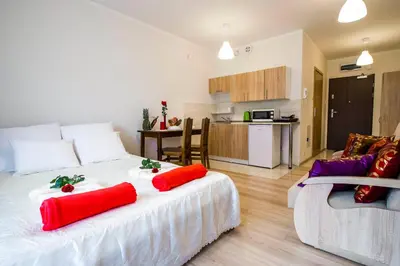 a bedroom with a large bed with red pillows on it at Apartament Polonijna in Kraków