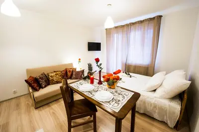 a living room with a table and a couch at Apartament Polonijna in Kraków