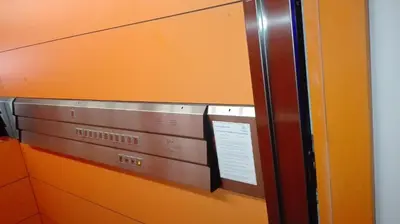 a close up of a microwave in an orange wall at Apartament Polonijna in Kraków