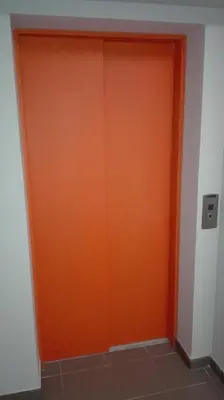 an orange garage door in a room at Apartament Polonijna in Kraków