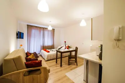 a living room with a couch and a table at Apartament Polonijna in Kraków