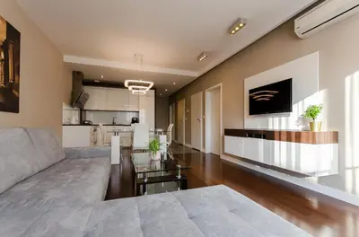 a living room with a couch and a kitchen at Old Town Luxury Apartments in Kraków