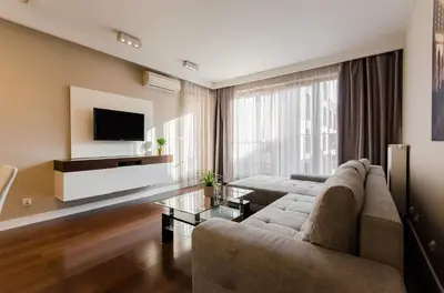 a living room with a couch and a tv at Old Town Luxury Apartments in Kraków