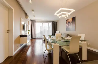 a dining room with a glass table and chairs at Old Town Luxury Apartments in Kraków