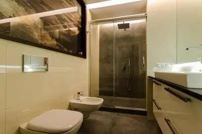 a bathroom with a toilet and a sink and a shower at Old Town Luxury Apartments in Kraków