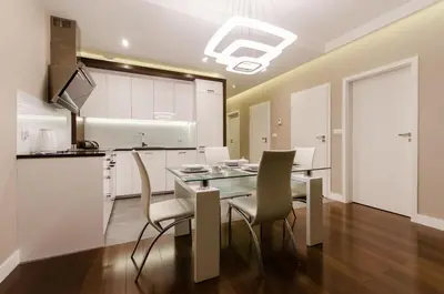 a kitchen and dining room with a table and chairs at Old Town Luxury Apartments in Kraków
