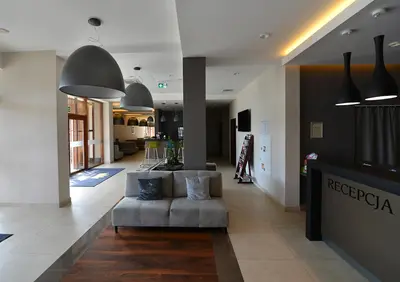 a living room with a couch in the middle at Hotel Imperiale in Oświęcim