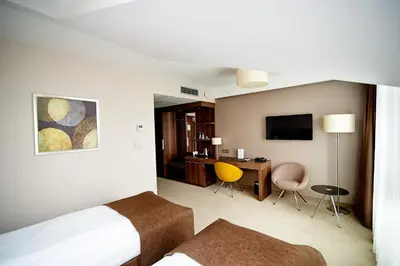 a hotel room with a bed and a desk at Hotel Imperiale in Oświęcim