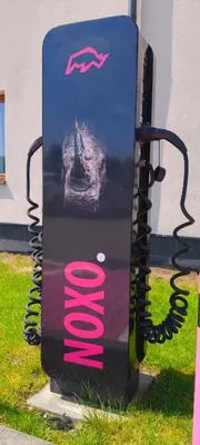 a sign that is sitting in the grass at Hotel Imperiale in Oświęcim