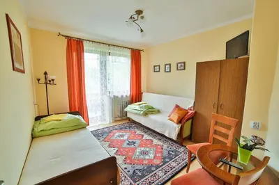a small room with a bed and a table at Ośrodek Wczasowy Sokół in Rabka