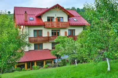 a large house with a red roof on a hill at Ośrodek Wczasowy Sokół in Rabka