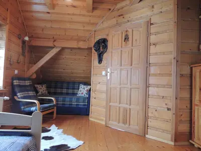 a room with a door in a log cabin at Apartament Suzyw Kicek in Sucha Beskidzka