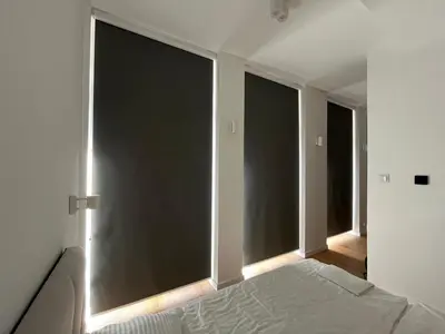 a bedroom with two large windows and a bed at Quiet Luxury Hideaway in Kraków