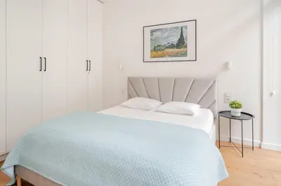 a tray with two cups and a bowl on a bed at Quiet Luxury Hideaway in Kraków