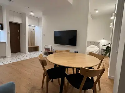 a bedroom with a bed and two large windows at Quiet Luxury Hideaway in Kraków