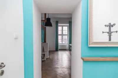 a hallway with blue and white walls and a mirror at Venice Lagoon Apartment in Kraków
