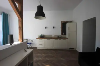 a kitchen with white cabinets and a counter top at Venice Lagoon Apartment in Kraków