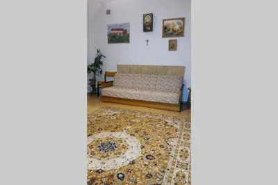 a living room with a couch and a rug at Feel The Old Socialist Style Apartment in Kraków