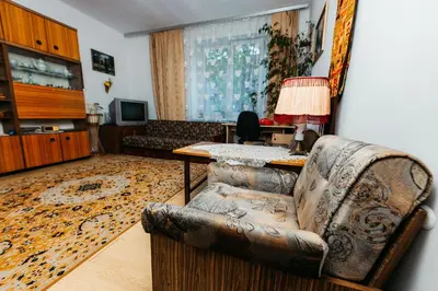 a living room with a couch and a table at Feel The Old Socialist Style Apartment in Kraków