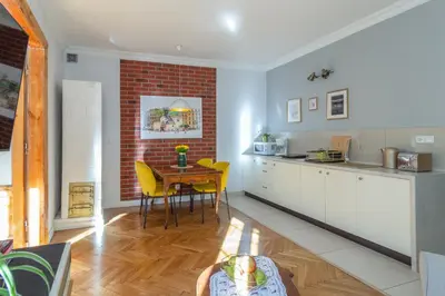 a living room with a couch and a table at Smile Apartments Center Kraków Old Town in Kraków