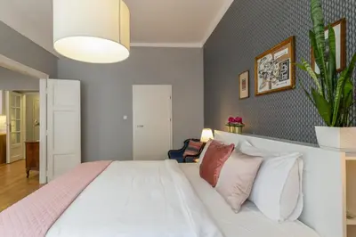a bedroom with a dresser with a mirror and a bed at Smile Apartments Center Kraków Old Town in Kraków