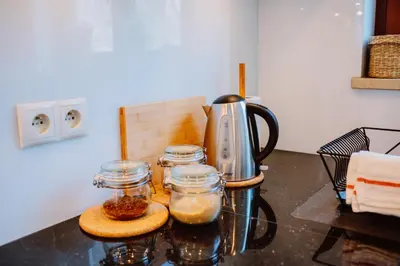 a kitchen counter with jars of food and a blender at Atticus Apartments in Kraków