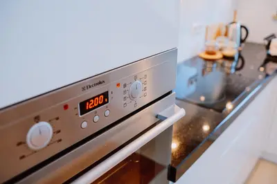 a close up of an oven with a clock on it at Atticus Apartments in Kraków