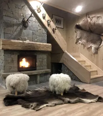 two sheep are standing in front of a fireplace at Domek nad Potokiem in Nowy Targ