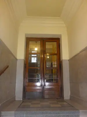 an entrance to a building with wooden doors at Garden Apartment in Kraków