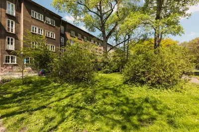 a grassy yard in front of a building at Garden Apartment in Kraków